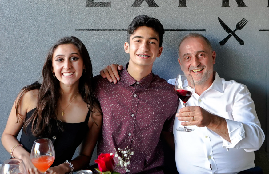 Guests toasting with wine inside Sapore Express in San Mateo